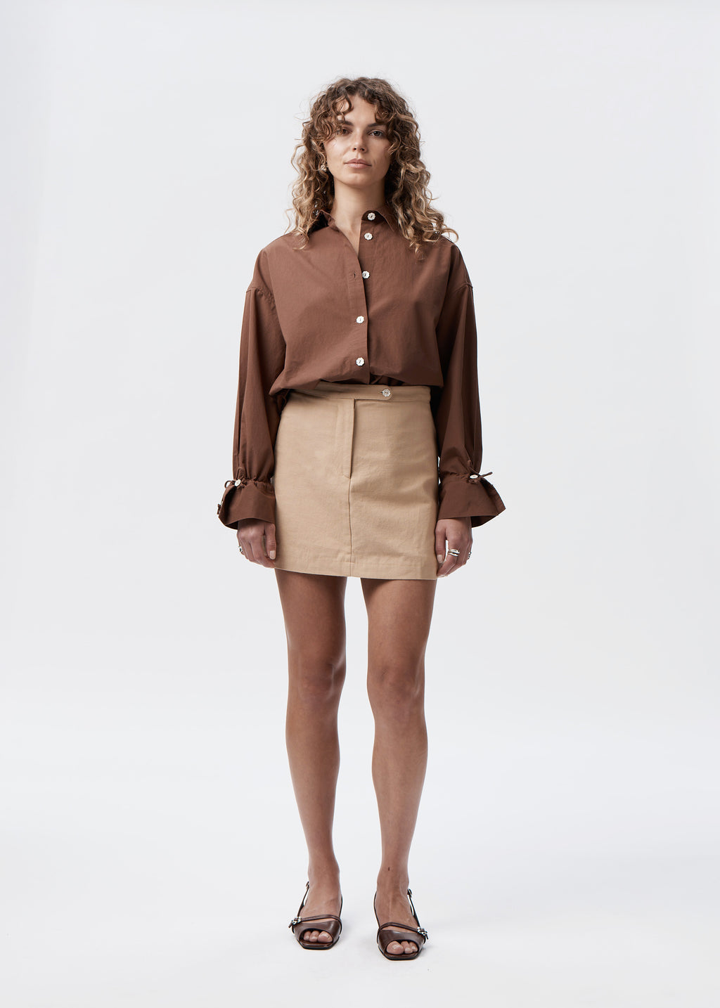 Say the Label Peggy Shirt in chocolate cotton poplin worn with a latte mini skirt, front view