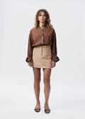 Say the Label Peggy Shirt in chocolate cotton poplin worn with a latte mini skirt, front view