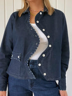 Close-up of the Say the Label Wave Denim Jacket showing the curved placket and mother-of-pearl buttons