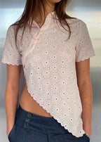 Say the Label Daisy Asymmetric Top in blush pink with daisy embroidery, worn with jeans