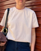 Say the Label Signature Tee in blush pink with contrast blanket-stitch trim, worn with denim