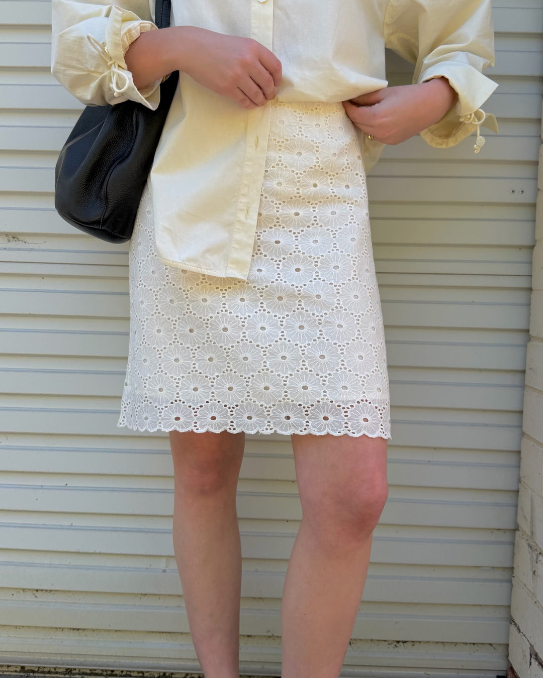 The scalloped hem of the Daisy Skirt Midi in Ivory