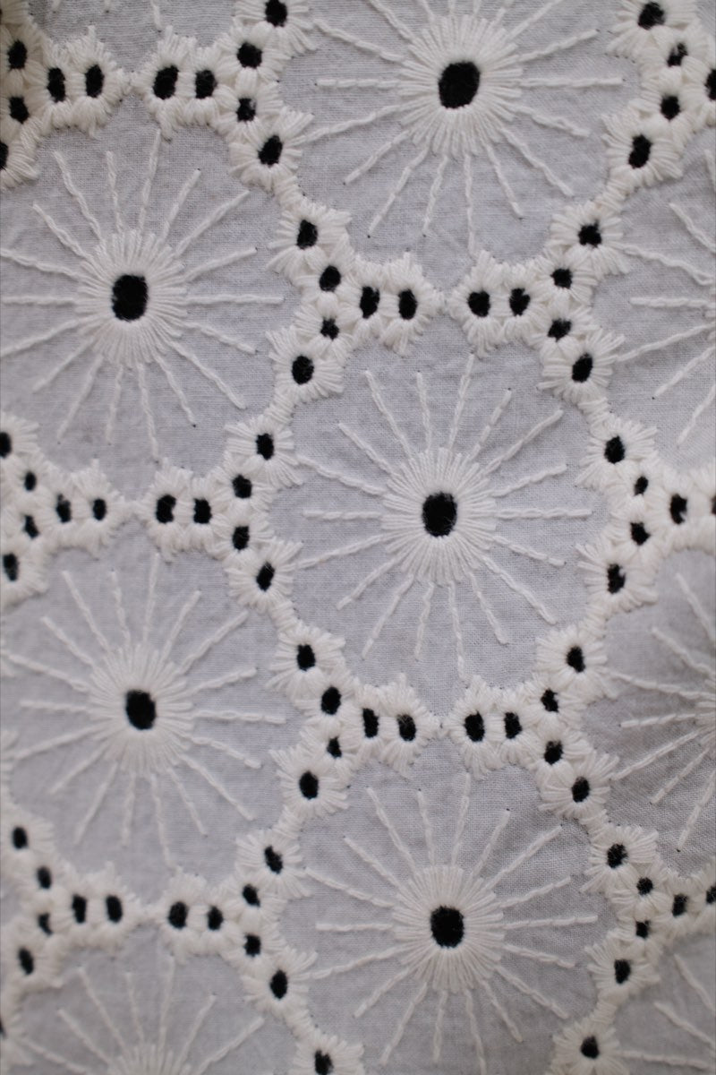 Daisy cutwork, embroidered and cut by machine, finished by hand